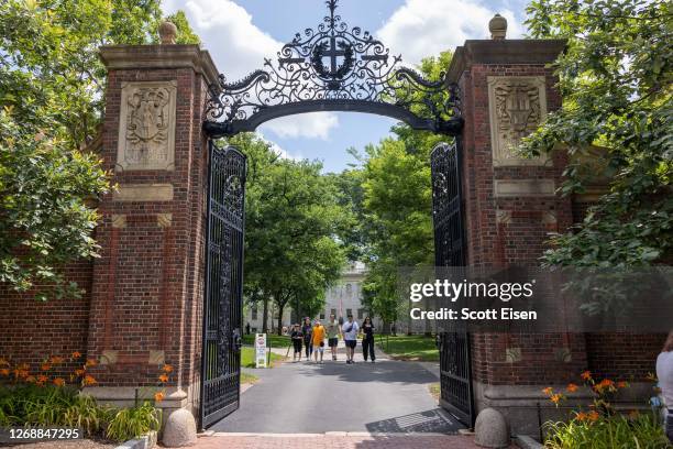 People walk through the gate on Harvard Yard at the Harvard University campus on June 29, 2023 in Cambridge, Massachusetts. The U.S. Supreme Court...