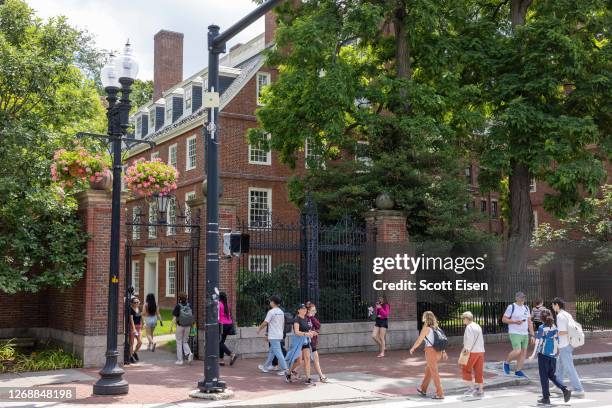 People walk through the gate on Harvard Yard at the Harvard University campus on June 29, 2023 in Cambridge, Massachusetts. The U.S. Supreme Court...