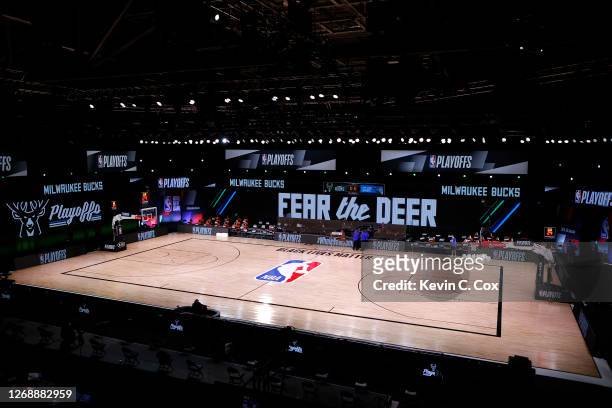 Referees huddle on an empty court at game time of a scheduled game between the Milwaukee Bucks and the Orlando Magic for Game Five of the Eastern...