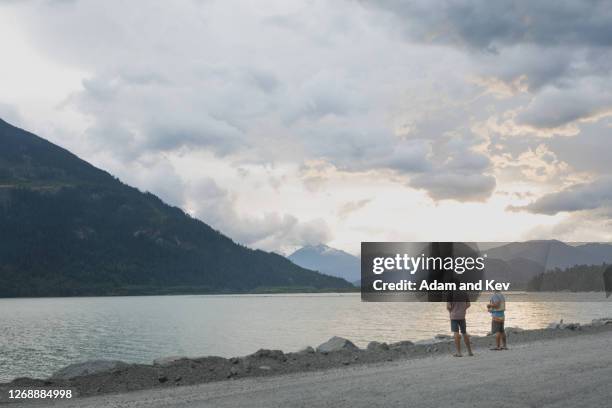 father and son on fishing trip at sunset - sons of adam stock pictures, royalty-free photos & images