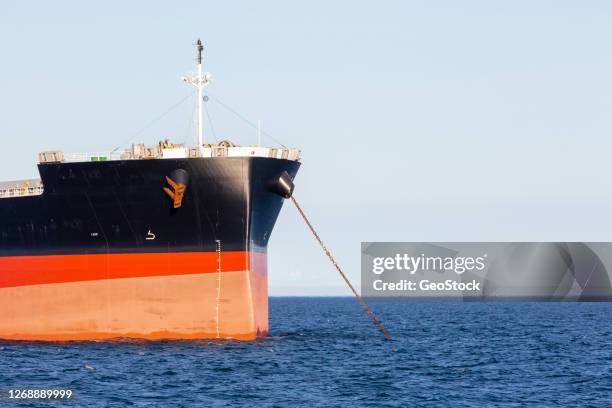 a cargo ship at anchor - schiffsbug stock-fotos und bilder