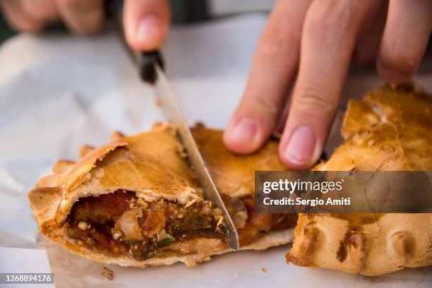 slicing a sicilian aubergine savoury pie - modica sicily stock pictures, royalty-free photos & images