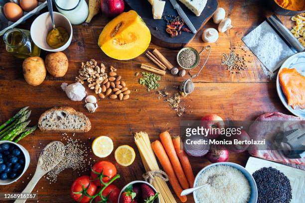 various types of food on wooden table - speisen und getränke stock-fotos und bilder