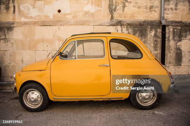 yellow cinquecento - old car side view stock pictures, royalty-free photos & images