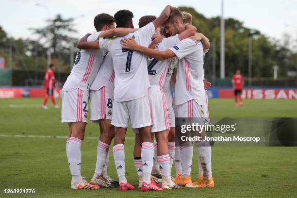 Real Madrid players celebrate after Sergio Arribas's cross was turned into his own goal by Henrique Jocu of Benfica to make the scoreline 2-0 during...