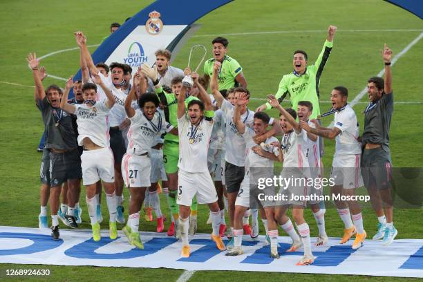 Real Madrid celebrate with the Winners' Trophy following the 3-2 victory over Benfica during the UEFA Youth League Final at Colovray Sports Centre on...