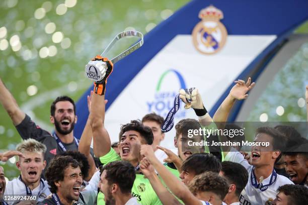 Real Madrid celebrate with the Winners' Trophy following the 3-2 victory over Benfica in the UEFA Youth League Final at Colovray Sports Centre on...