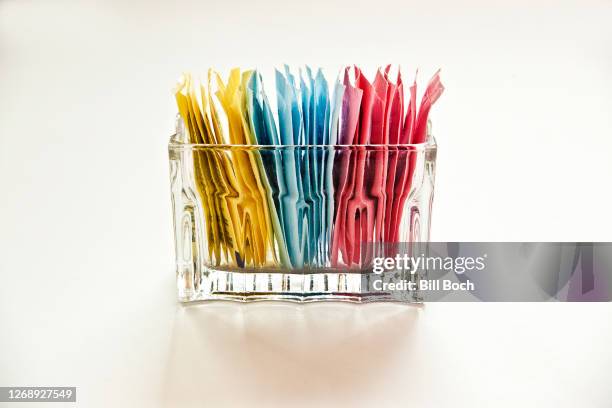 artificial sweeteners in a clear glass container on a white, cut out, background - artificial fotografías e imágenes de stock