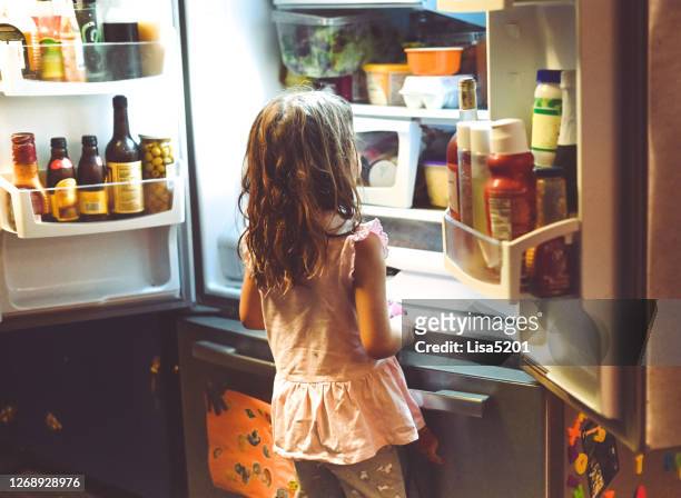 child looks into messy family refrigerator - funny fridge stock pictures, royalty-free photos & images