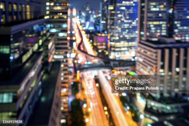 blurred abstract background aerial view of bangkok cbd downtown city night lights colorful bokeh in cool vintage cyan turquoise blue tone: central business district on electric train line over river - earth hour bildbanksfoton och bilder