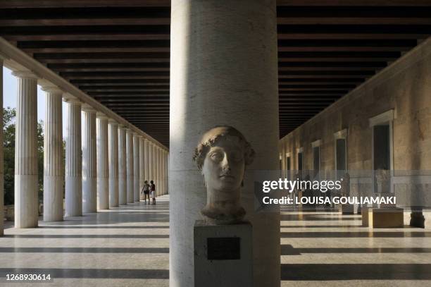 Tourists visit the 159-138 B.C Stoa of Attalos, a gift from the King of Pergamon Attalos II, at the Ancient Agora, in Athens, on August 13, 2010. AFP...