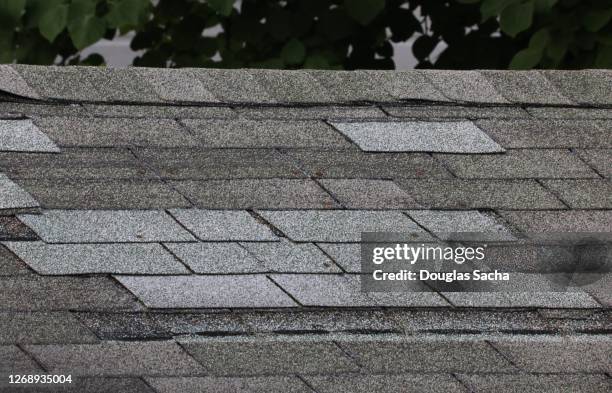 neglected roof with missing shingles - damaged shingles stock pictures, royalty-free photos & images