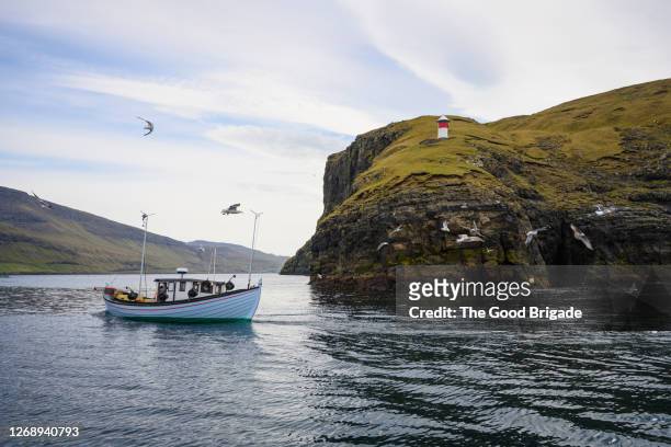 boat in water, tindholmur, faroe islands - îles féroé photos et images de collection