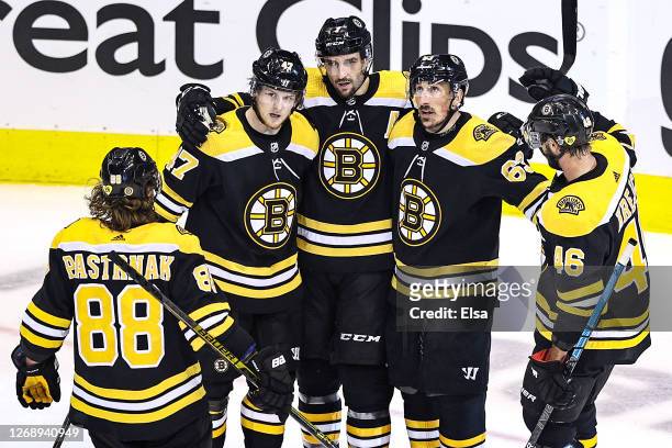 Brad Marchand of the Boston Bruins is congratulated by his teammates after scoring a goal against the Tampa Bay Lightning during the second period in...