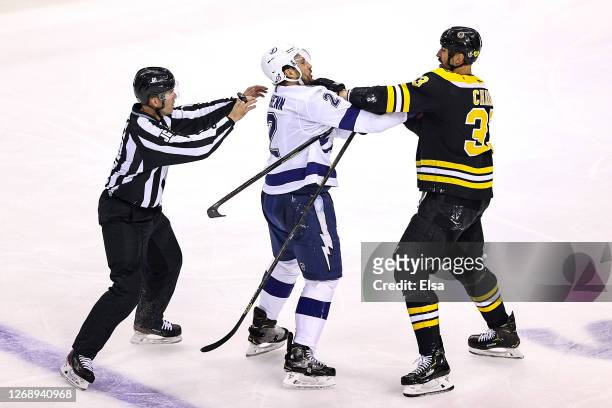 Luke Schenn of the Tampa Bay Lightning scuffles with Zdeno Chara of the Boston Bruins during the second period in Game Three of the Eastern...