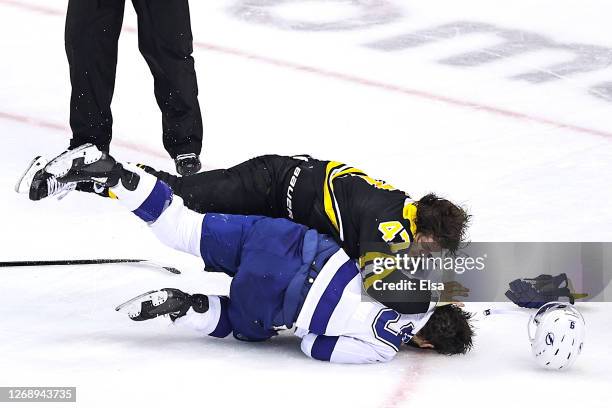 Torey Krug of the Boston Bruins fights with Tyler Johnson of the Tampa Bay Lightnin during the second period in Game Three of the Eastern Conference...