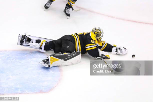 Dan Vladar of the Boston Bruins dives for the puck against the Tampa Bay Lightning during the second period in Game Three of the Eastern Conference...