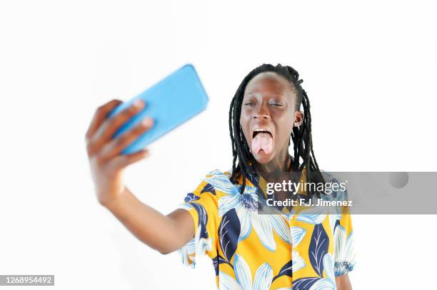 woman taking a selfie with mobile phone on white background - taking selfie white background stock-fotos und bilder