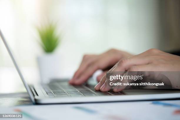 close up of hand typing on laptop at the office. - candidato imagens e fotografias de stock