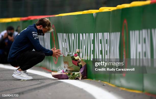 Pierre Gasly of France and Scuderia AlphaTauri leaves flowers at the side of the track in tribute to the late Formula 2 driver Anthoine Hubert, who...