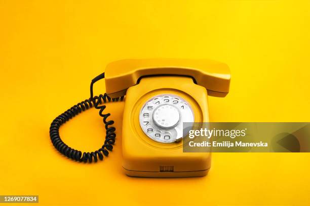 yellow rotary phone - vintage telephone stock-fotos und bilder