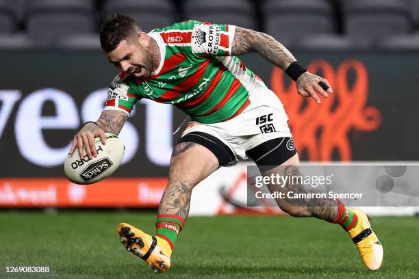 Adam Reynolds of the Rabbitohs scores a try is tackled during the round 16 NRL match between the Parramatta Eels and the South Sydney Rabbitohs at...