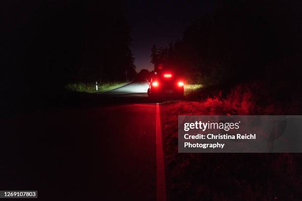 car parking at the side of the road at night - car night stock pictures, royalty-free photos & images