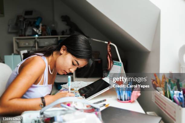 female hispanic teenager doing some homeworks during online classes - university covid stock pictures, royalty-free photos & images