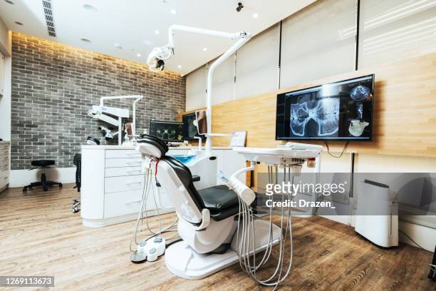 modern empty dentist's office - dentist's chair stock pictures, royalty-free photos & images