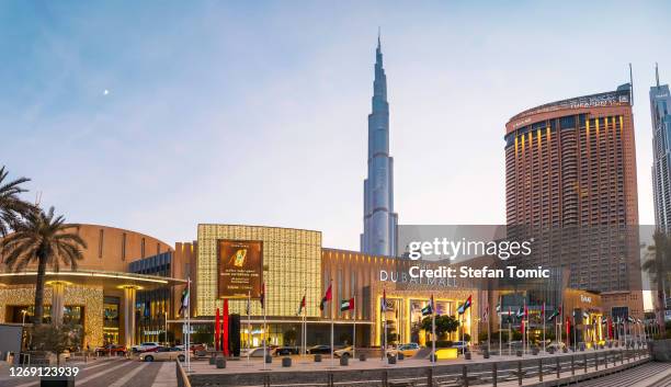 dubai mall main entrance with burj khalifa in rising in the background - dubai mall stock pictures, royalty-free photos & images