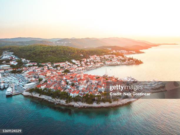 aerial old seaside town korcula at sunset, surrounded by clear blue waters - korcula island stock pictures, royalty-free photos & images