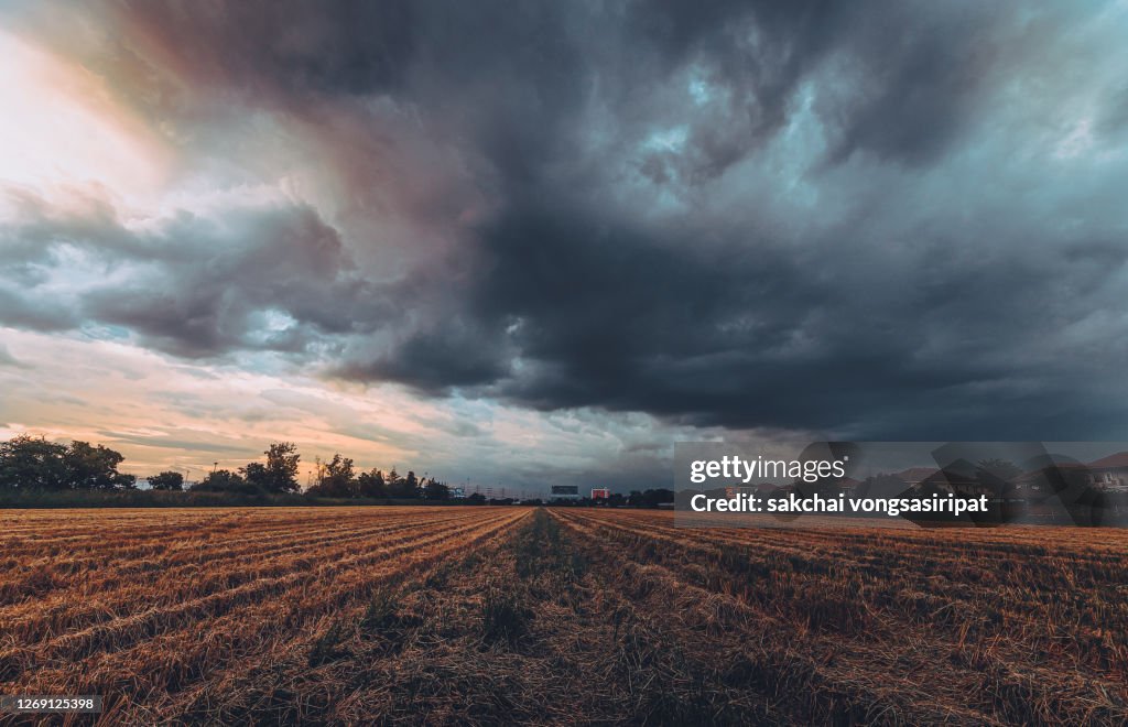 Low Angle View of Storm Cloud Over Farm During Sunset