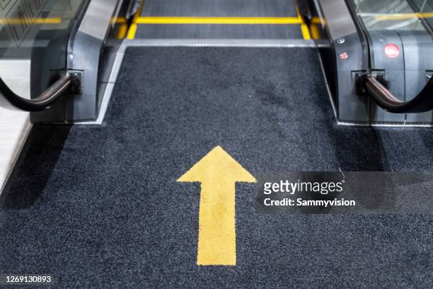 arrow signs at escalator - carpet icon stock pictures, royalty-free photos & images