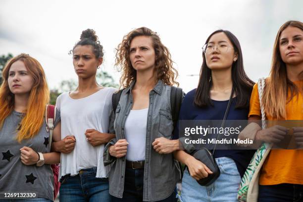 women standing together - group arm in arm stock pictures, royalty-free photos & images