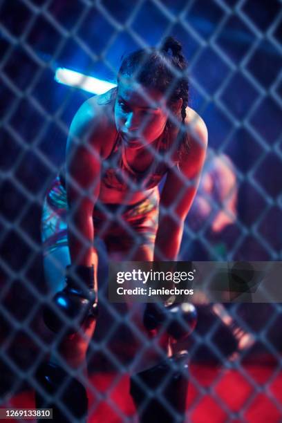 mma training in octagon. female fighter taking a breath - mixed martial arts stock pictures, royalty-free photos & images