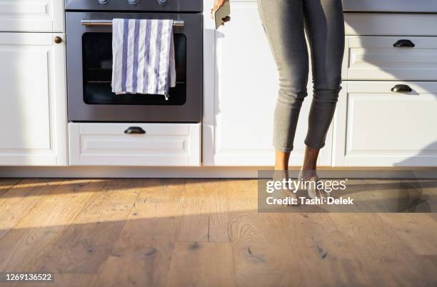 slim female dancing at the countertop - pies bailando fotografías e imágenes de stock