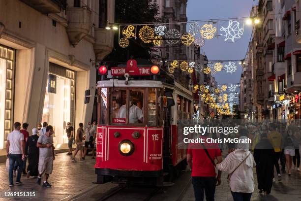 People walk on Istanbul's famous Istiklal shopping street on August 27, 2020 in Istanbul, Turkey. Turkey's economy is in danger of contracting, as...