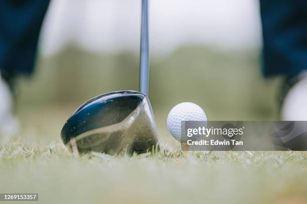 an asian chinese senior man tee off at golf course with his driver club - golf ball tee stock pictures, royalty-free photos & images