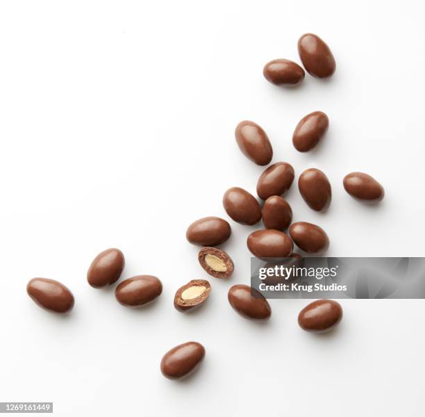 chocolate covered almonds on white - chocolate dipped stock pictures, royalty-free photos & images