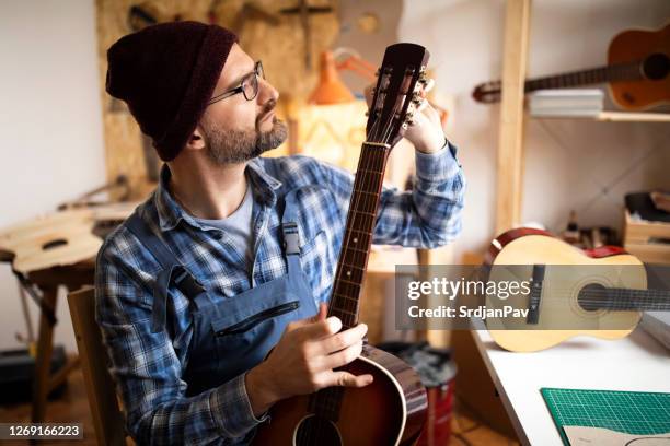 surrounded by guitars - guitar shop stock pictures, royalty-free photos & images