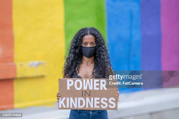 beautiful african american woman holding a protest sign - anti racism masks stock pictures, royalty-free photos & images