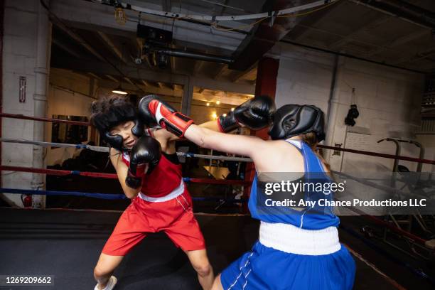 sparring female boxers with one boxer throwing left handed punch to the head. - dodging stock pictures, royalty-free photos & images
