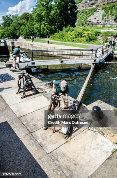 men opening locks for a boat - ottawa locks stock pictures, royalty-free photos & images