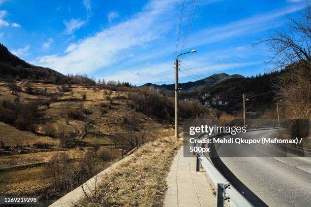 scenic view of road by mountains against sky, shipka, bulgaria - shipka stock pictures, royalty-free photos & images