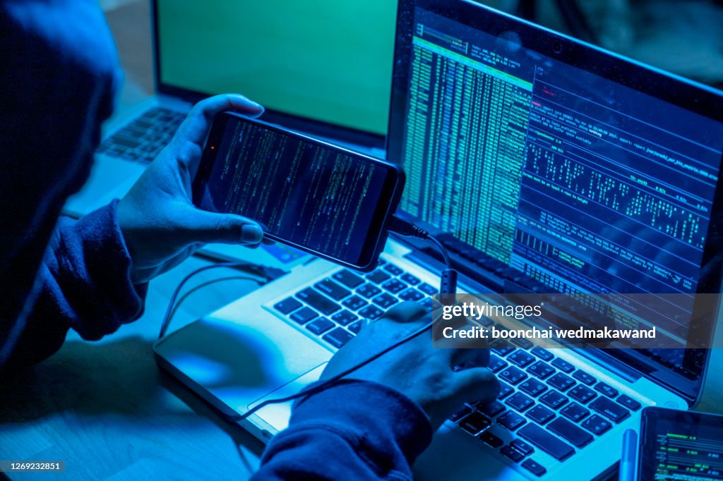Hacker with computers in dark room. Cyber crime
