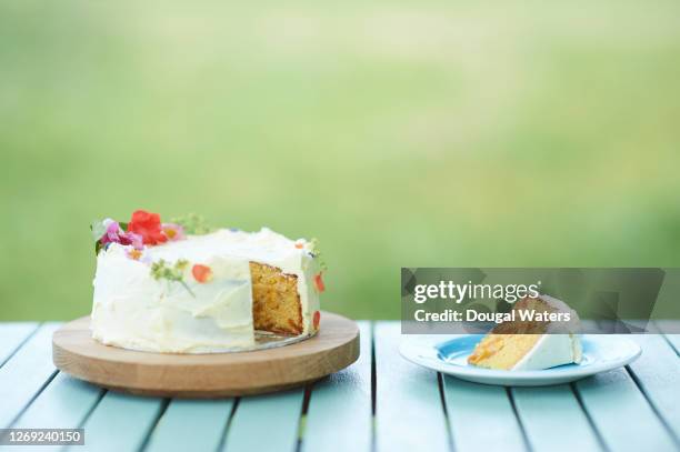 homemade gluten free apricot and almond cake decorated with edible flowers. - cake slices stock pictures, royalty-free photos & images