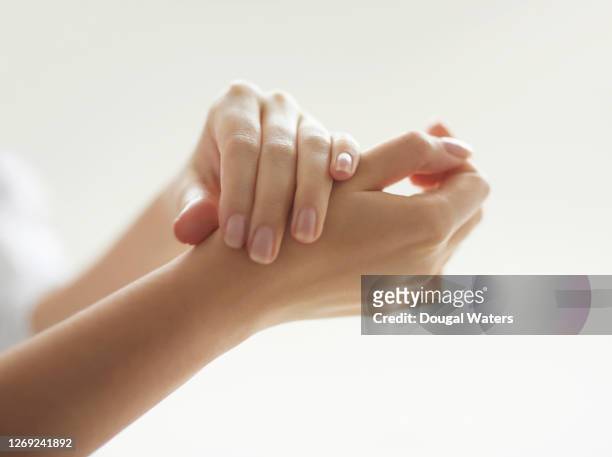 woman rubbing hands together, close up. - hand cream 個照片及圖片檔