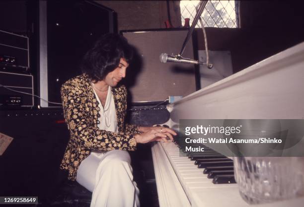 Freddie Mercury of Queen at a white grand piano during rehearsing and recording of 'A Night At The Opera' album at Ridge Farm Studios, West Sussex,...