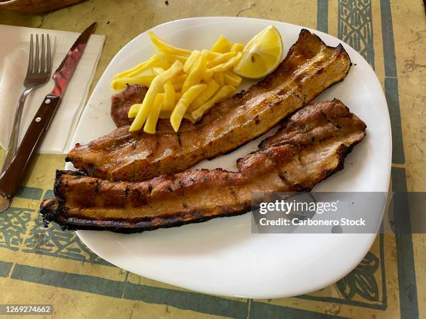 plate with two grilled bacon with fries - burnt pot stock pictures, royalty-free photos & images