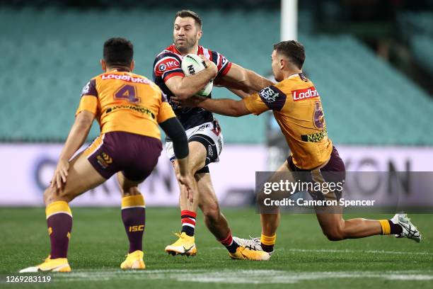 James Tedesco of the Roosters is tackled during the round 16 NRL match between the Sydney Roosters and the Brisbane Broncos at the Sydney Cricket...